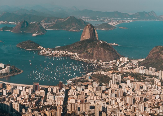 Aerial photo of Rio de Janeiro surrounded by the sea and hills under the sunlight in Brazil